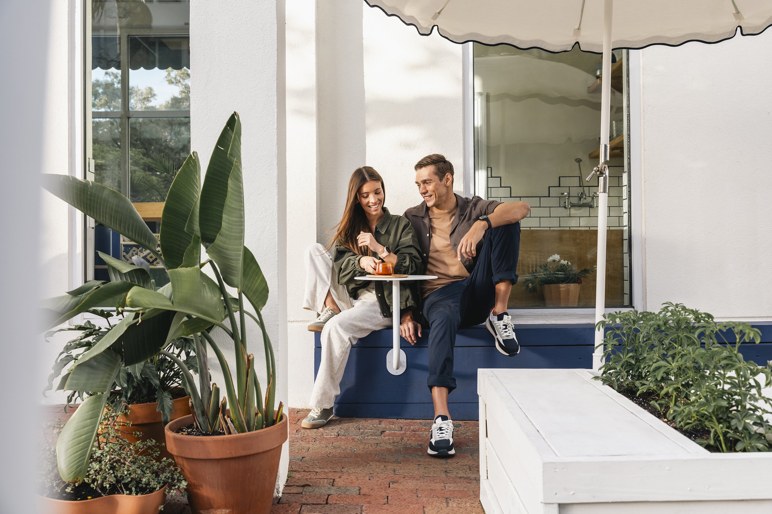 Couple cast for a lifestyle campaign on a sunlit patio