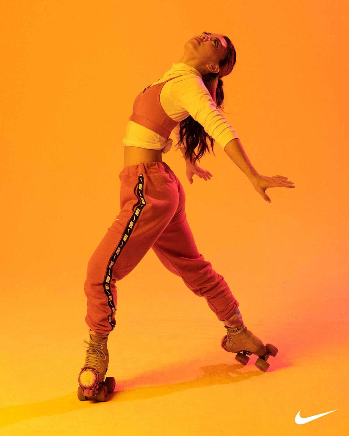 Roller skater cast for a Nike campaign on an orange studio backdrop
